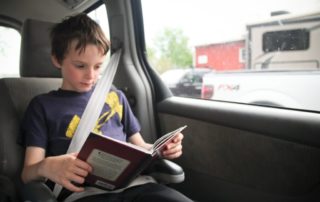 Child reading in the car