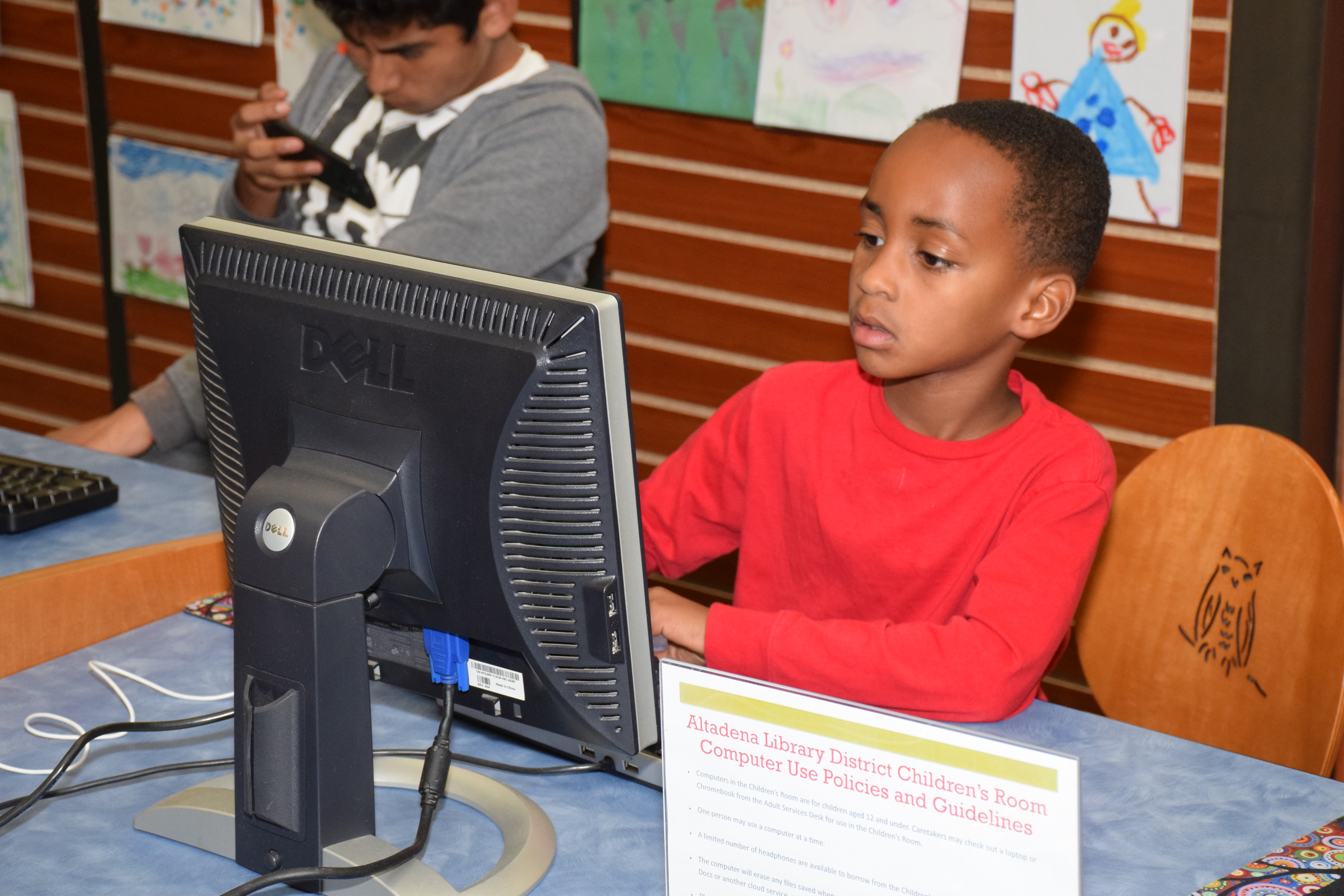 Young child using a computer in the children's office